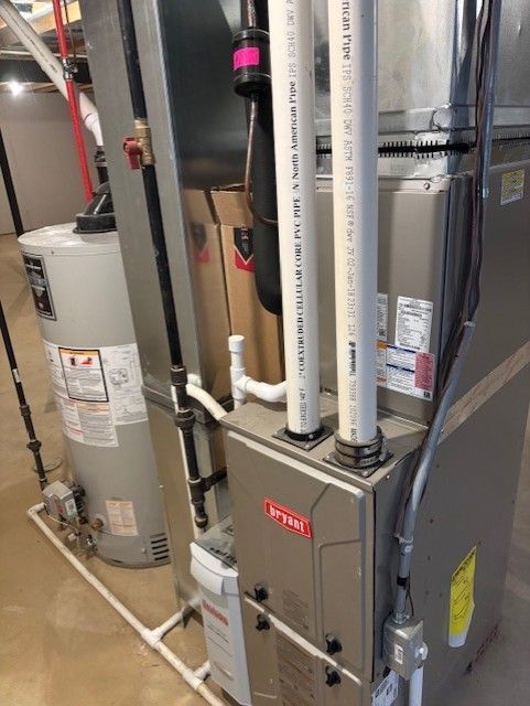 utility room featuring heating unit and gas water heater