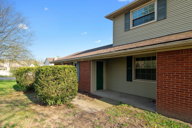 exterior space featuring brick siding