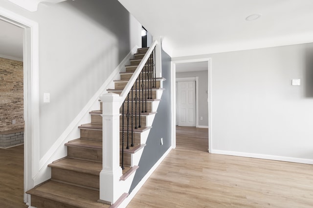 stairway featuring baseboards and wood finished floors