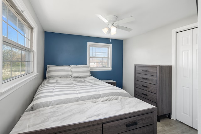 bedroom with a ceiling fan and light wood finished floors