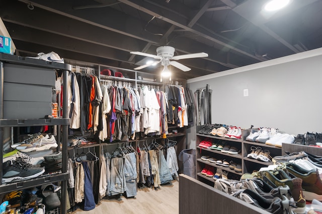 spacious closet featuring a ceiling fan and wood finished floors