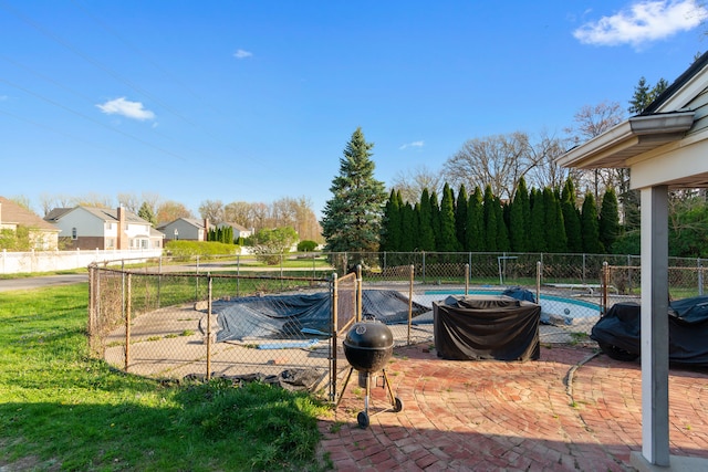 view of swimming pool with a fenced in pool, fence, a yard, and a patio