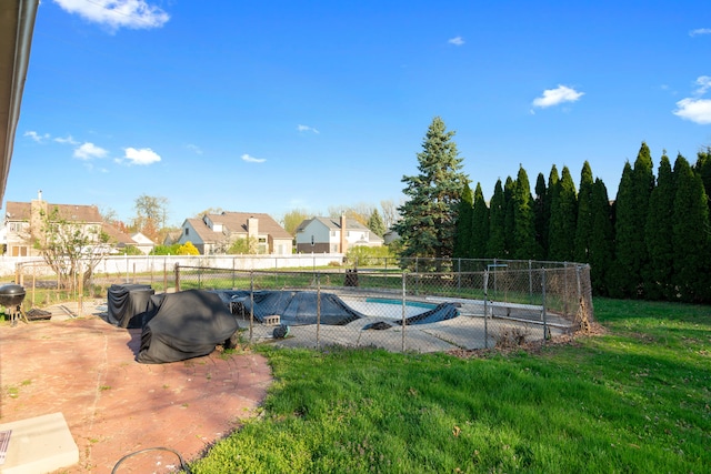 view of swimming pool with a fenced in pool, a patio, a yard, and a fenced backyard