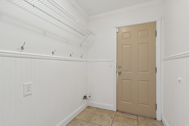laundry area featuring light tile patterned floors, a wainscoted wall, and ornamental molding