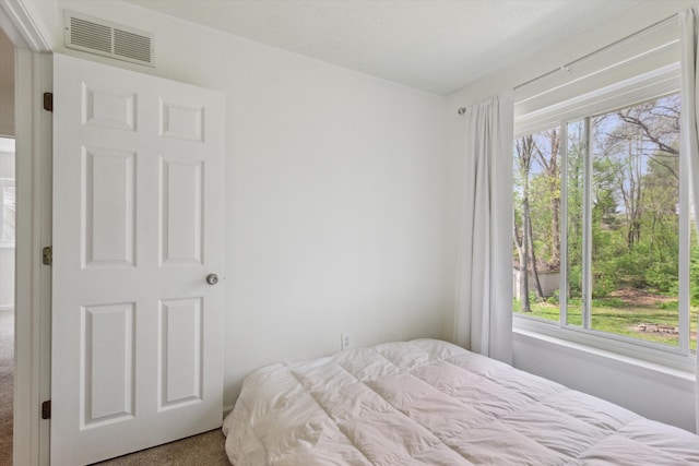 bedroom featuring carpet floors and visible vents