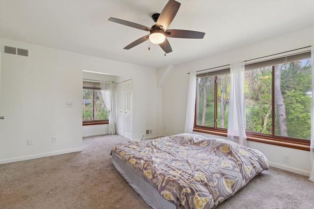 bedroom featuring visible vents, carpet, baseboards, and a closet