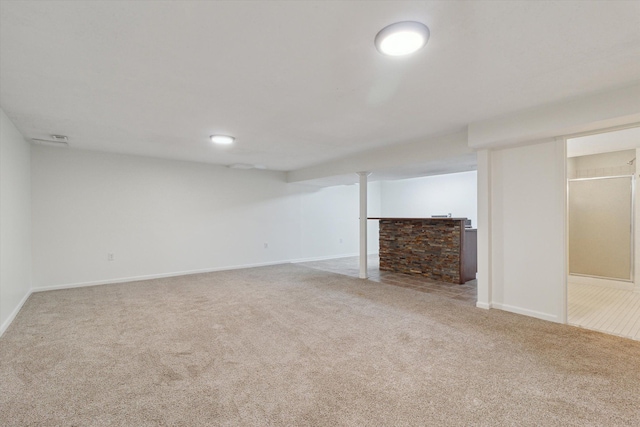 finished basement featuring carpet floors and baseboards