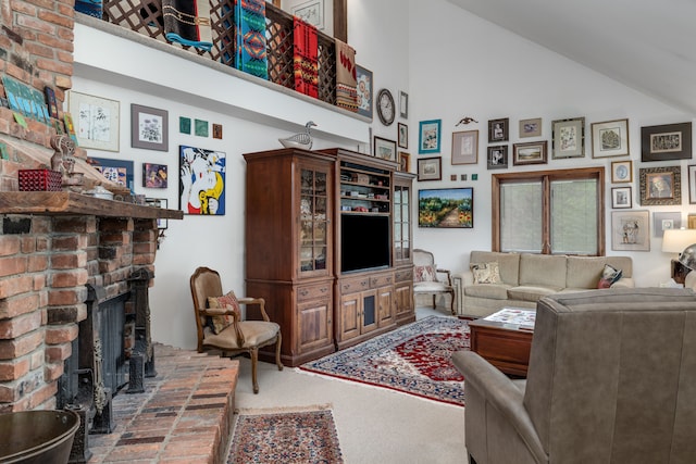 living room with carpet floors, high vaulted ceiling, and a fireplace