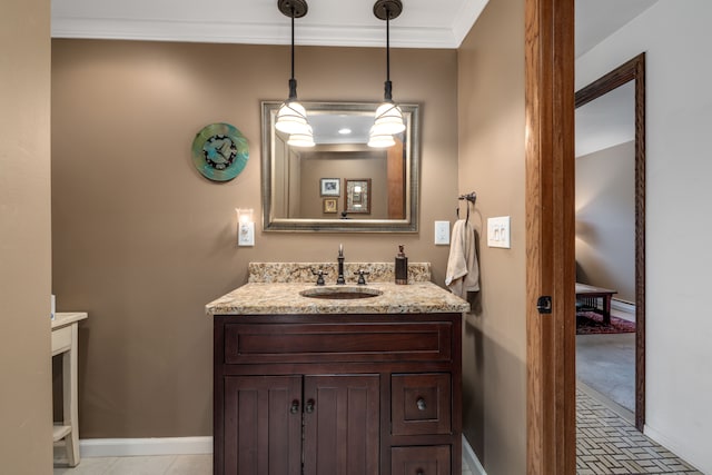 bathroom featuring vanity, ornamental molding, and baseboards