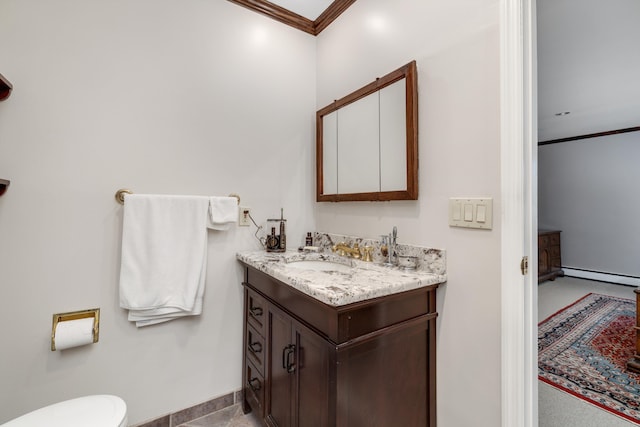 bathroom with vanity, baseboards, a baseboard heating unit, toilet, and ornamental molding
