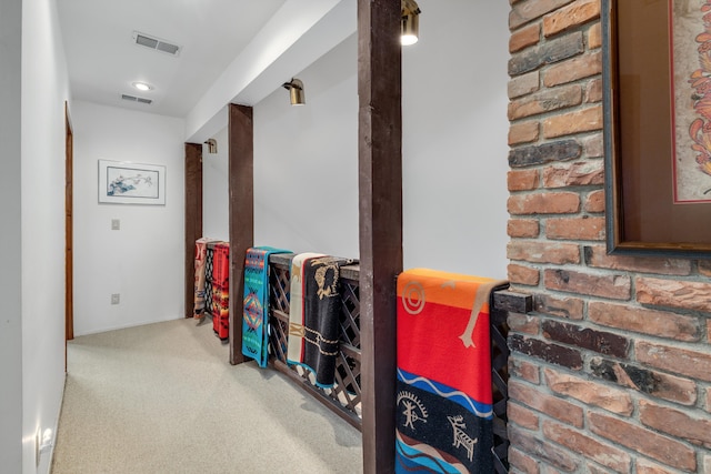 hall with carpet floors and visible vents