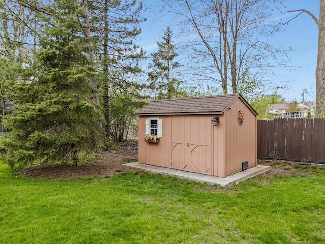 view of shed featuring fence