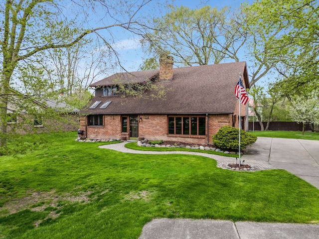 view of front of house with fence, a shingled roof, a front lawn, brick siding, and a chimney