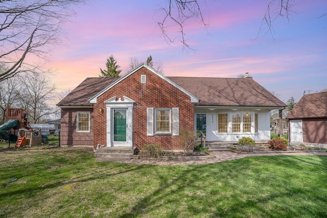 1016 Argyle Ct, Alma, MI 48801 - ranch-style home with brick siding, a shingled roof, a yard, and a chimney