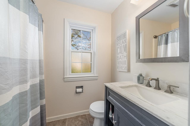 1016 Argyle Ct, Alma, MI 48801 - bathroom featuring tile patterned flooring, vanity, toilet, baseboards, and visible vents