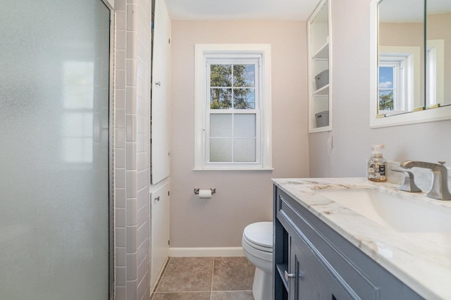 1016 Argyle Ct, Alma, MI 48801 - bathroom with an enclosed shower, vanity, baseboards, tile patterned floors, and toilet
