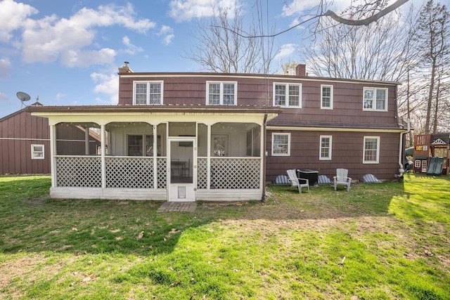 1016 Argyle Ct, Alma, MI 48801 - rear view of property featuring a yard, a chimney, and a sunroom