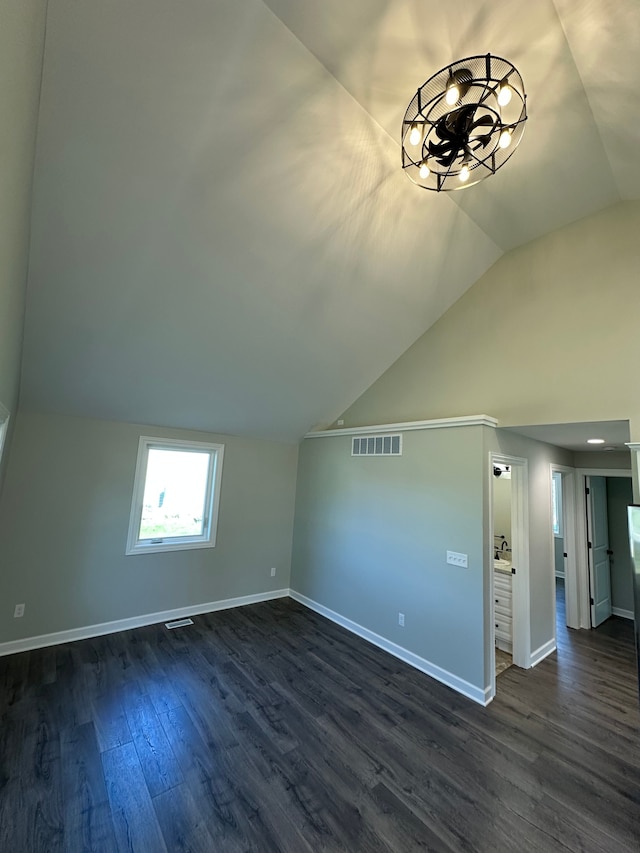 1052 Angle Rd, Lapeer, MI 48446 - additional living space with an inviting chandelier, dark wood finished floors, baseboards, lofted ceiling, and visible vents
