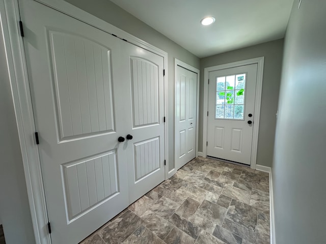 1052 Angle Rd, Lapeer, MI 48446 - doorway to outside featuring baseboards, stone finish floor, and recessed lighting