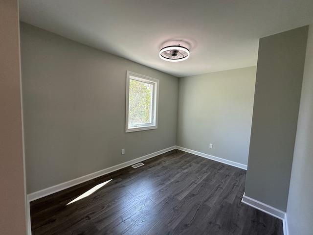 1052 Angle Rd, Lapeer, MI 48446 - unfurnished room featuring visible vents, baseboards, and dark wood-style floors