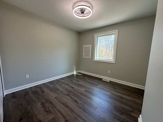 1052 Angle Rd, Lapeer, MI 48446 - empty room with baseboards, visible vents, and dark wood-type flooring