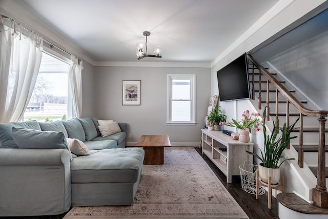 living room featuring a notable chandelier, dark wood finished floors, baseboards, and stairway