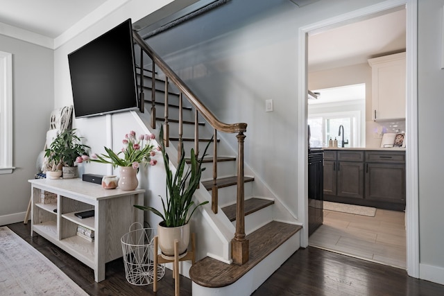 stairway with baseboards and wood finished floors