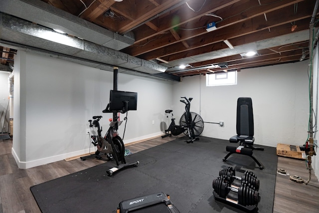 workout area with baseboards and dark wood-style floors