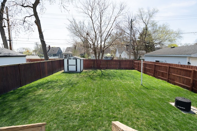 view of yard with a residential view, an outbuilding, a shed, and a fenced backyard