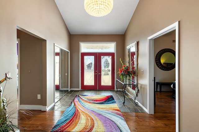 32560 N River Rd, Harrison Township, MI 48045 - entryway with lofted ceiling, a chandelier, french doors, wood finished floors, and baseboards