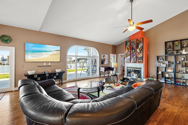 32560 N River Rd, Harrison Township, MI 48045 - living area with vaulted ceiling, hardwood / wood-style floors, ceiling fan, a fireplace, and baseboards