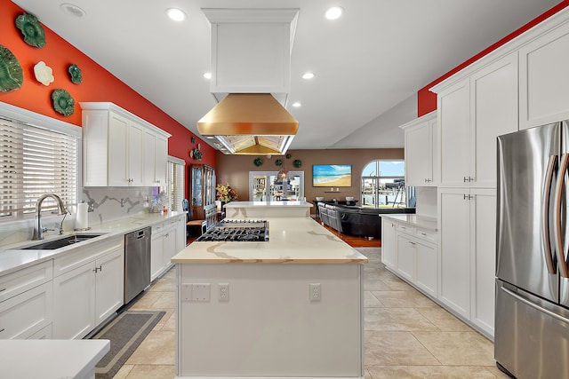 32560 N River Rd, Harrison Township, MI 48045 - kitchen featuring appliances with stainless steel finishes, a sink, a kitchen island, vaulted ceiling, and white cabinetry