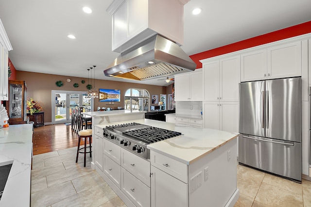 32560 N River Rd, Harrison Township, MI 48045 - kitchen featuring stainless steel appliances, island range hood, ceiling fan, white cabinets, and light stone counters