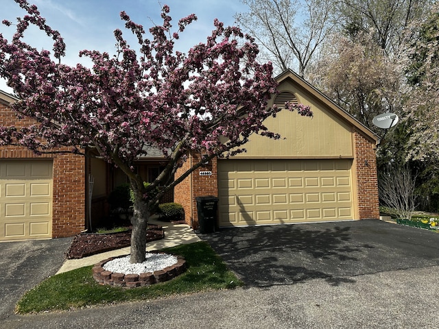 46980 Country Ln Unit 8, Macomb, MI 48044 - obstructed view of property featuring brick siding and an attached garage