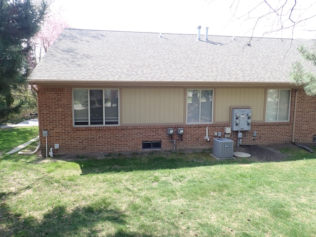 46980 Country Ln Unit 8, Macomb, MI 48044 - rear view of property with brick siding, roof with shingles, central air condition unit, and a yard