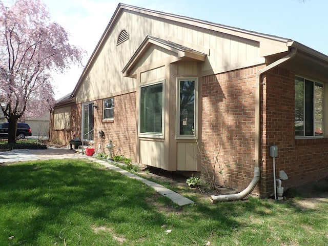 46980 Country Ln Unit 8, Macomb, MI 48044 - view of side of property with brick siding, a lawn, and entry steps