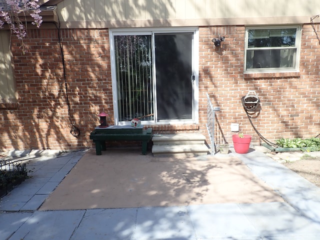46980 Country Ln Unit 8, Macomb, MI 48044 - doorway to property with brick siding and a patio