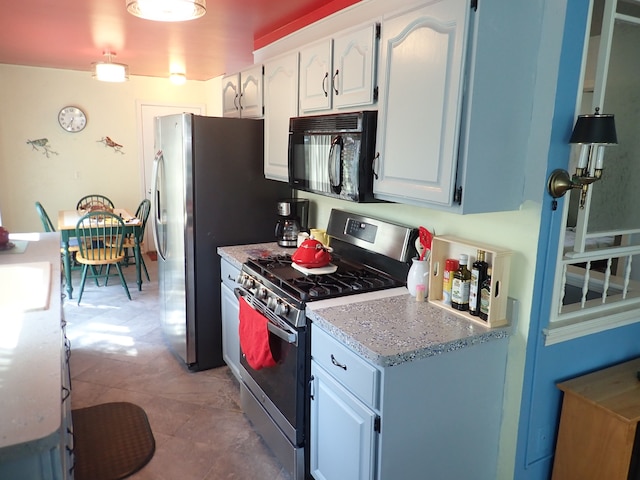 46980 Country Ln Unit 8, Macomb, MI 48044 - kitchen featuring light countertops, appliances with stainless steel finishes, and white cabinetry