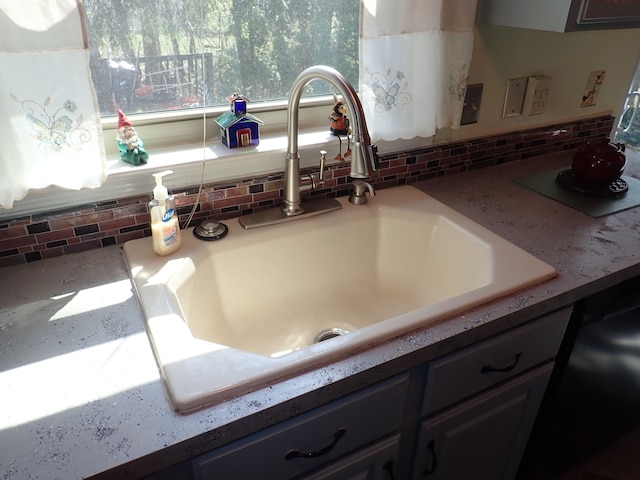 46980 Country Ln Unit 8, Macomb, MI 48044 - details with a sink, black dishwasher, and tasteful backsplash