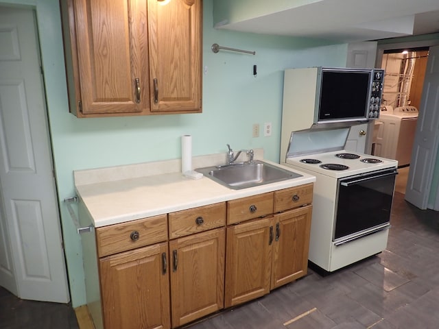 46980 Country Ln Unit 8, Macomb, MI 48044 - kitchen featuring white electric range, a sink, washing machine and dryer, and light countertops