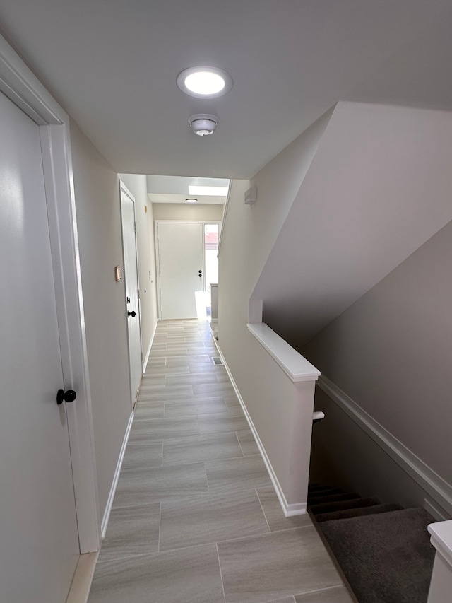 hallway featuring baseboards