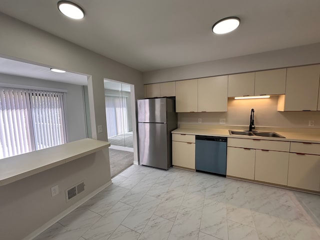 kitchen featuring freestanding refrigerator, marble finish floor, dishwashing machine, light countertops, and a sink