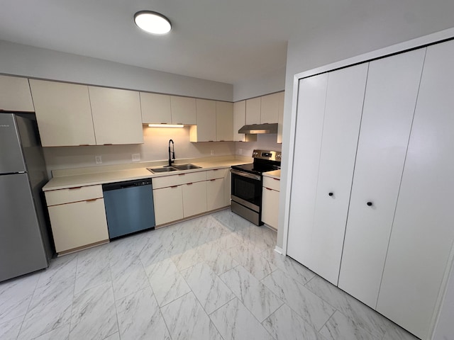 kitchen with appliances with stainless steel finishes, a sink, light countertops, marble finish floor, and under cabinet range hood