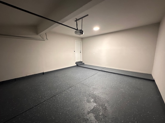 garage featuring baseboards and a garage door opener