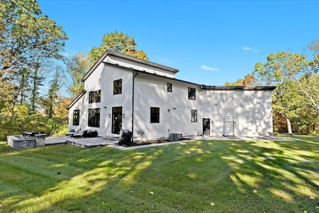 back of property featuring a lawn, cooling unit, and a patio area