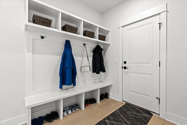 mudroom with baseboards and marble finish floor