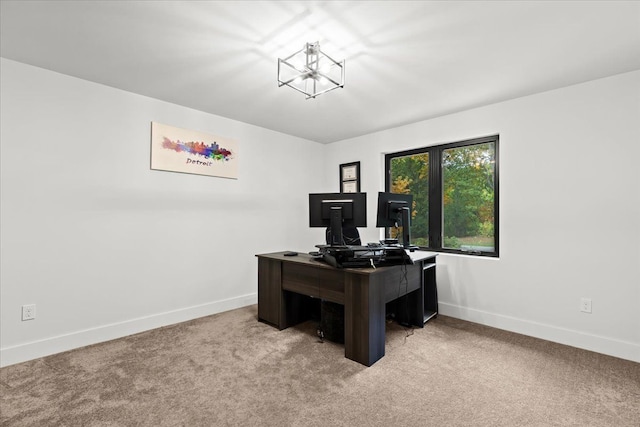 office space with carpet floors, baseboards, and a chandelier