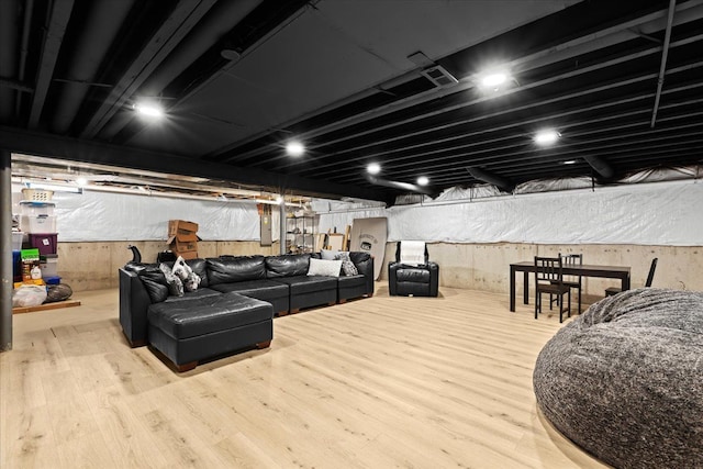 basement with wood finished floors and electric panel
