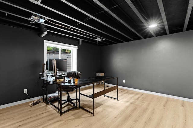 office space featuring baseboards and wood finished floors