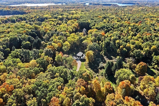 birds eye view of property with a water view and a view of trees